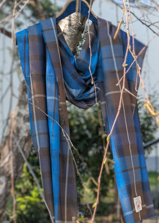 Zu sehen ist ein feiner Merinowollschal im Tartan Buchanan blue - blau mit braun